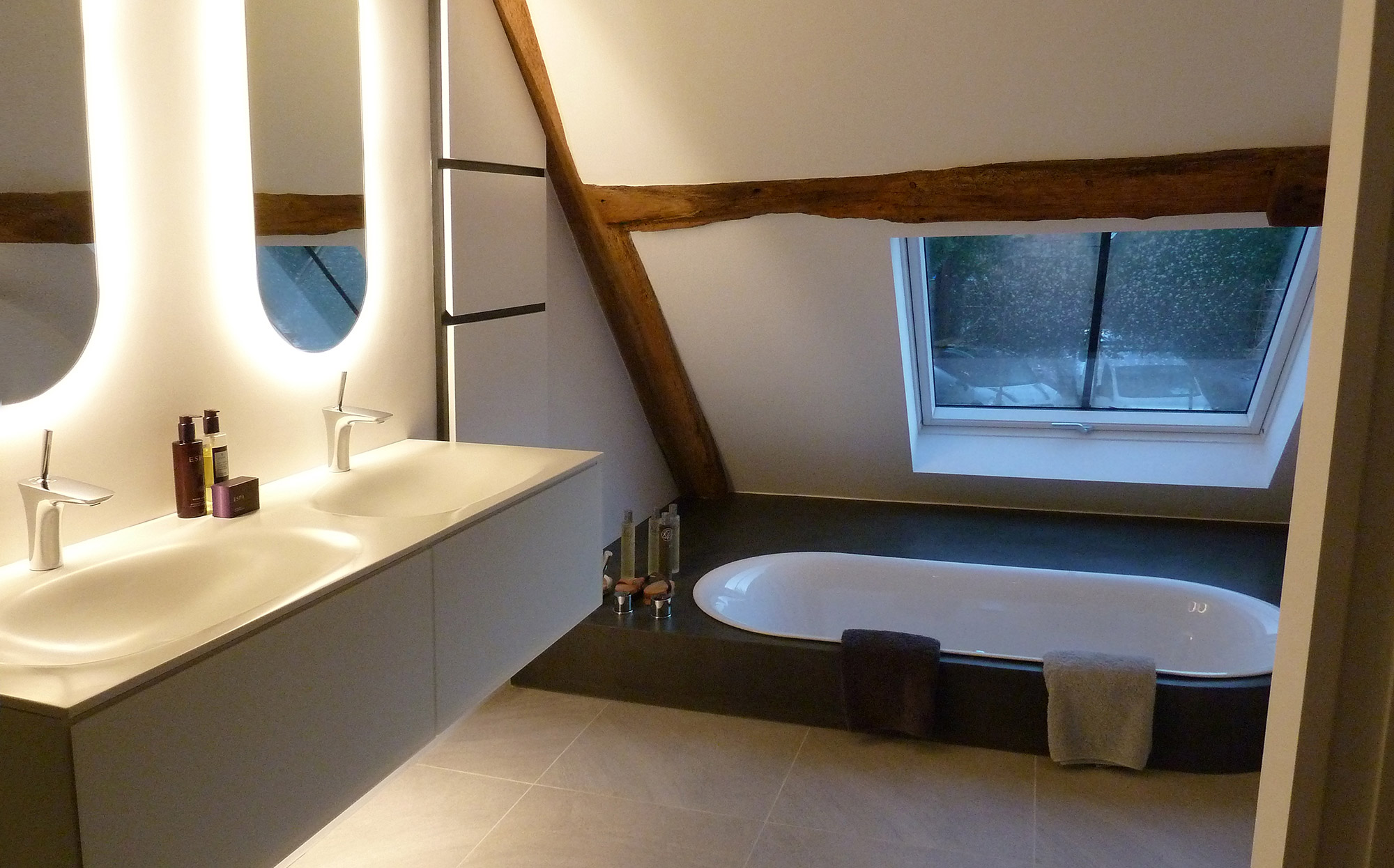 Bathroom with sunken bath in converted tythe barn