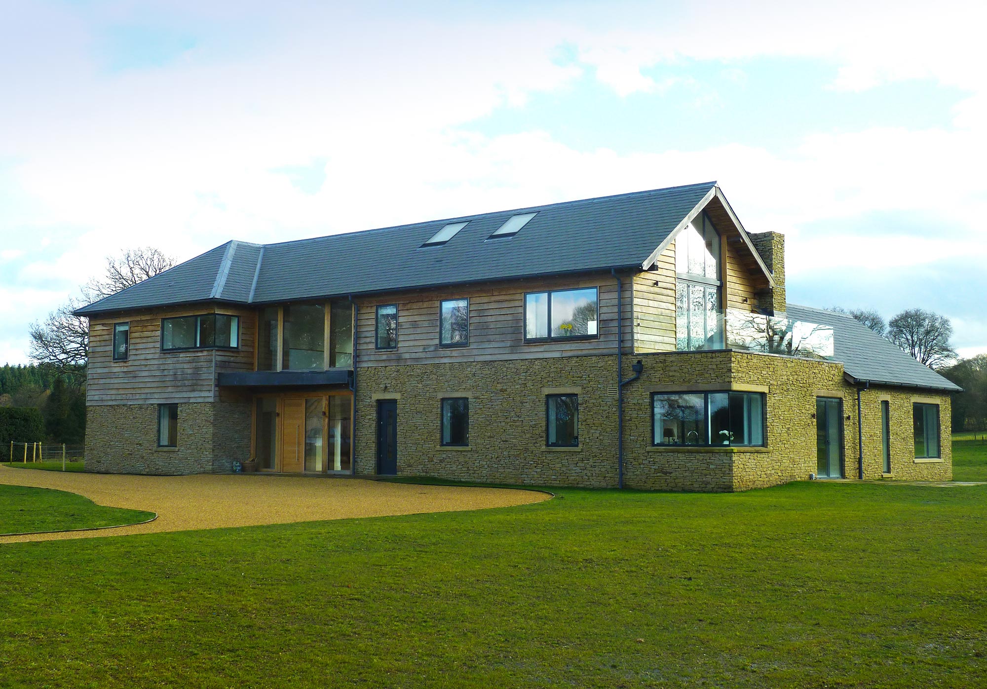 New build home with oak frame, stone and specialist glass - Castle Eaton Construction, Surrey