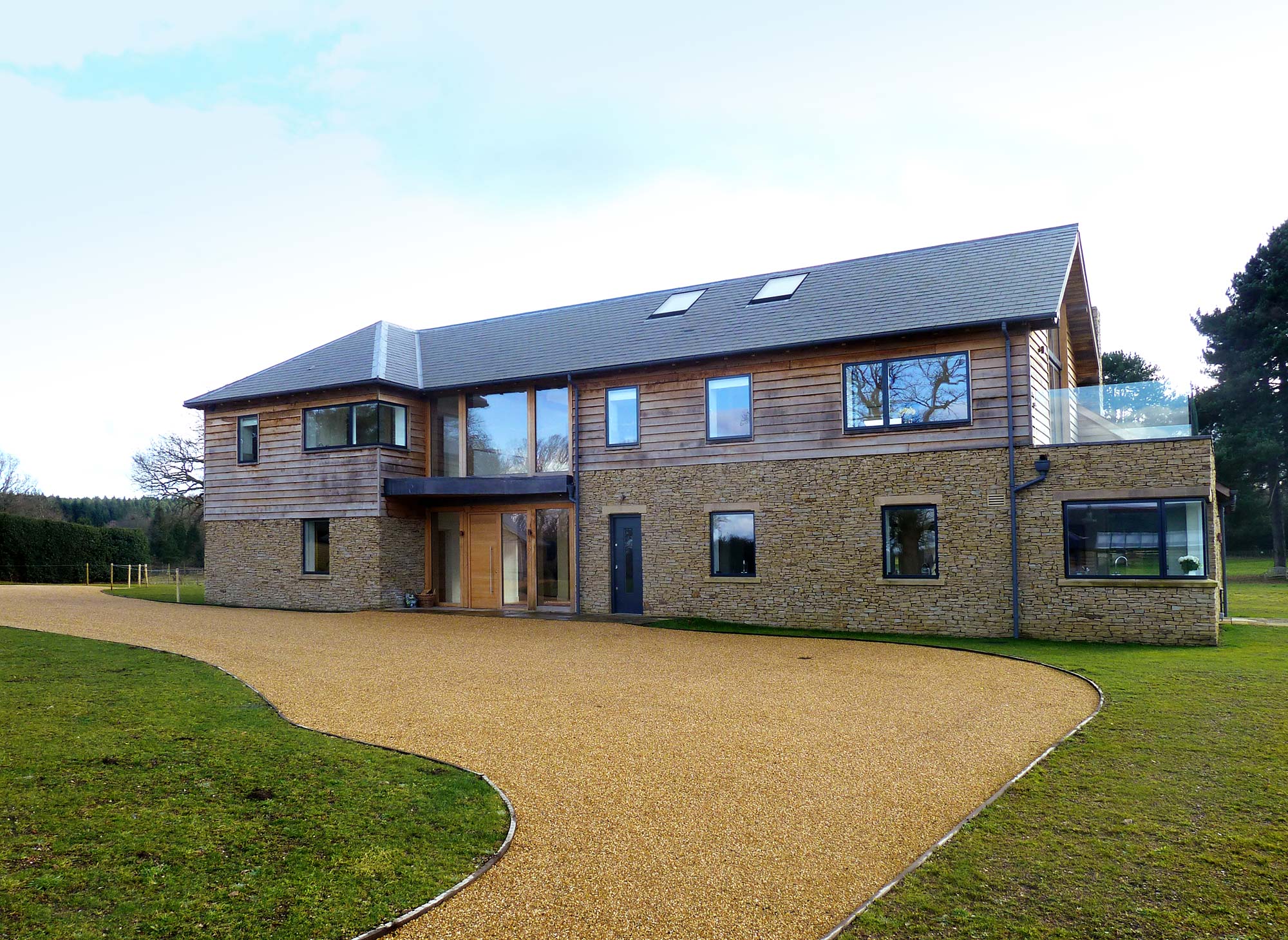 New build home with oak frame, stone and specialist glass - Castle Eaton Construction, Surrey